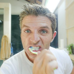 Man brushes teeth