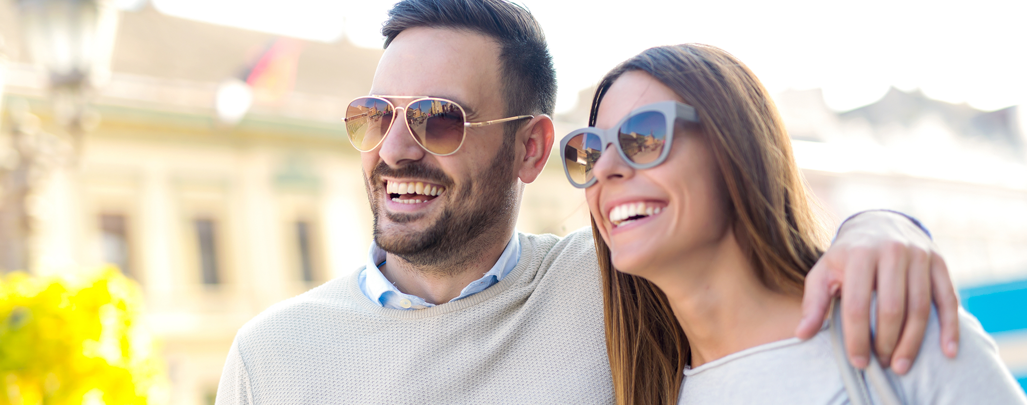 Couple smiling outdoors with All on 4 dental implants in Sterling Heights