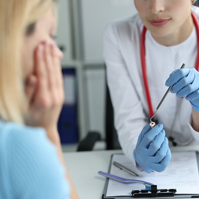 Dentist showing a restoration to a patient