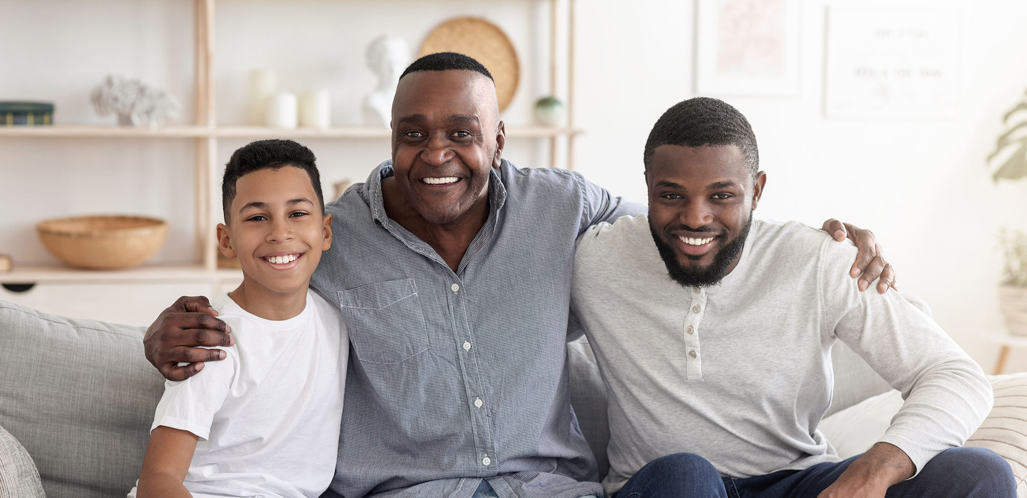 Boy smiling with his father and grandfather