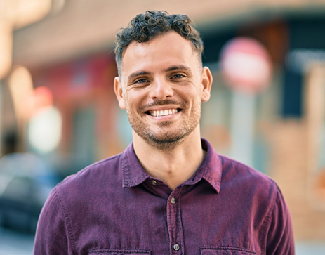 Smiling man in a purple button down shirt
