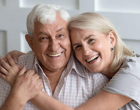 Senior couple hugging and smiling