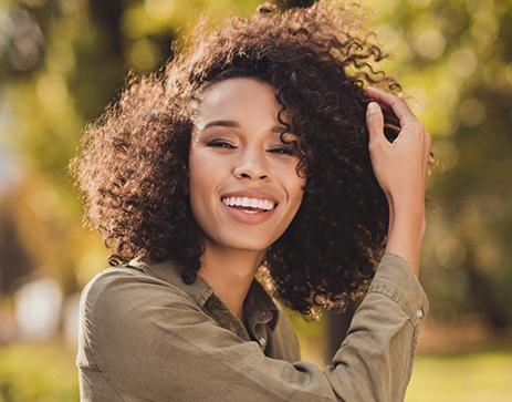 Woman smiling outdoors in the sun