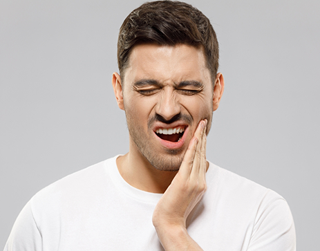 Man holding his jaw in pain