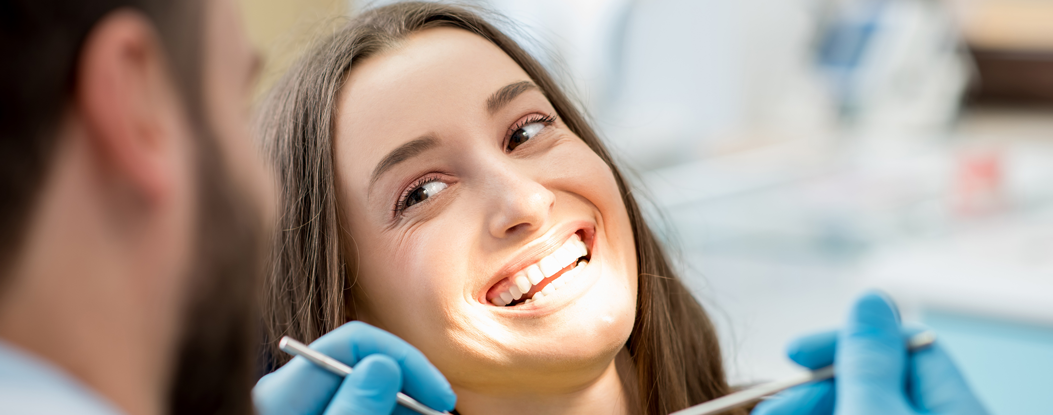 Dental patient smiling at her dentist
