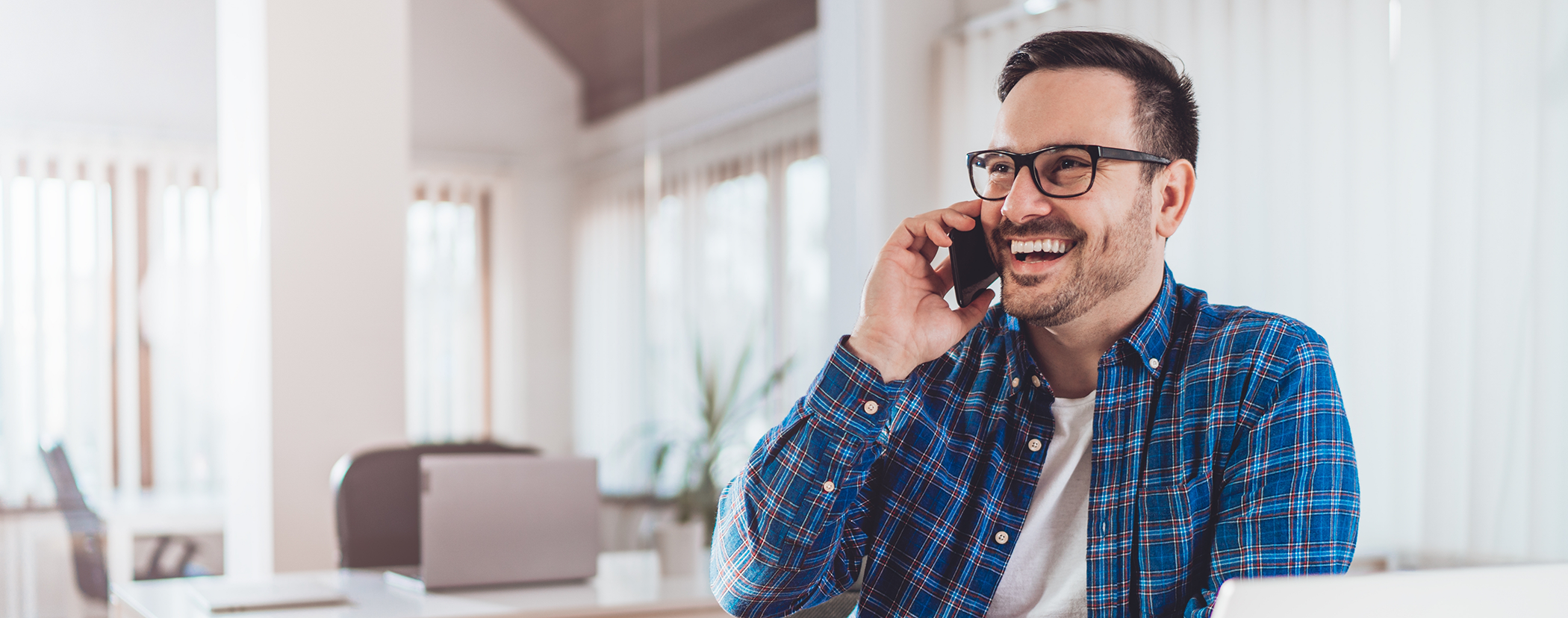 Man talking on the phone to request a dental appointment in Sterling Heights