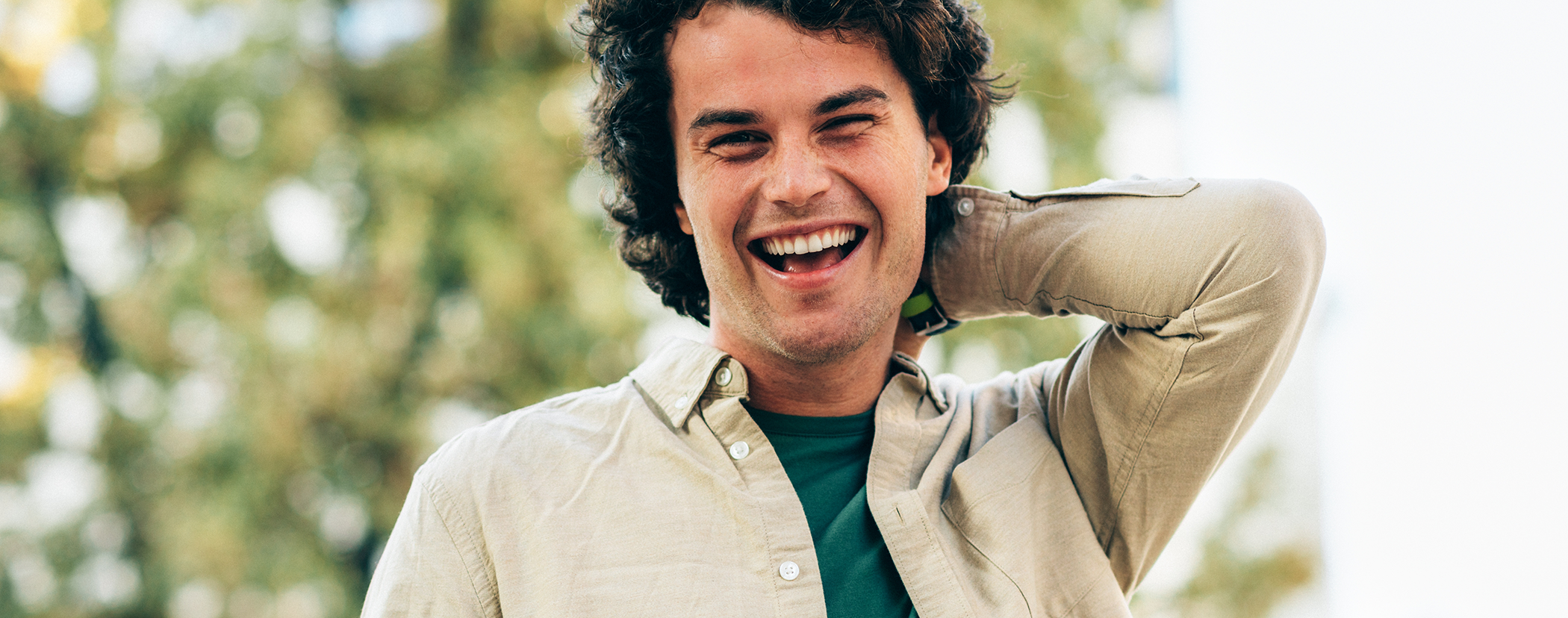 Young man smiling outdoors in the sun