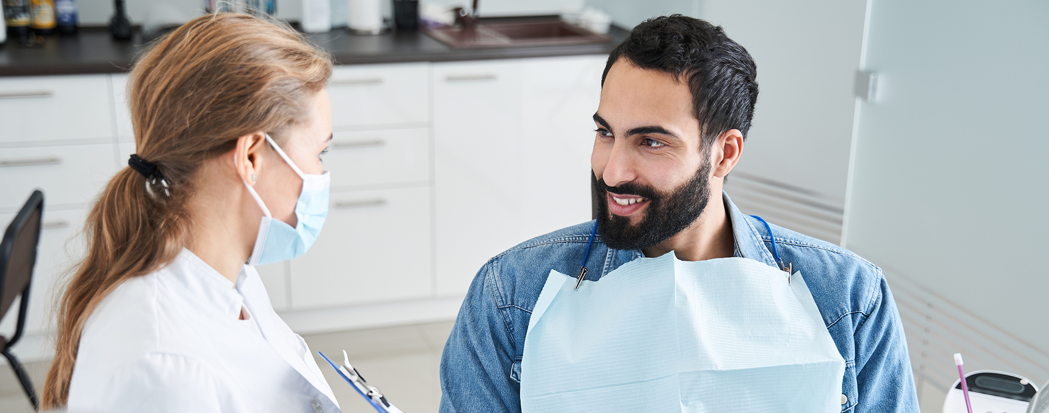 Man talking to his dentist about tooth colored fillings in Sterling Heights